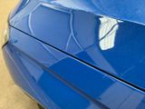 a close up of a car ' s hood with a wing on it