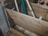 a wooden crate filled with potatoes in a barn