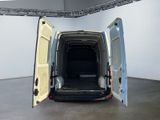 a white van with its doors open in a large room
