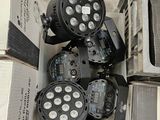 four lights that are sitting in a box on the floor