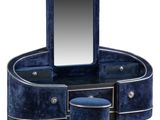 a close up of a vanity with a mirror and stool