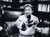 an old black and white photo of a man holding a gun