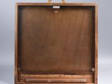 an empty wooden box with a handle on a white background