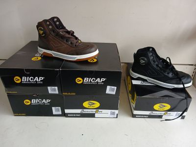 two pairs of shoes that are on top of boxes