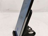 a cell phone that is on a stand on the table