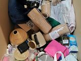 a cardboard box filled with assorted items and a cell phone