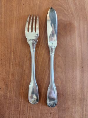 two spoons and a fork on a wooden table