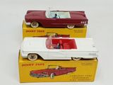 two toy cars that are sitting on top of each other