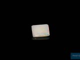 an oplite stone on a black surface with a black background