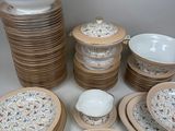 a lot of plates and bowls that are sitting on a table