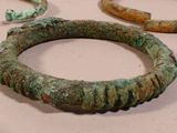 several pieces of ancient bronze bracelets are on a table