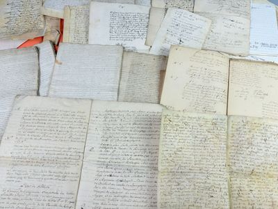 a pile of old papers sitting on top of a table