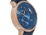 a close up of a wrist watch with a blue dial