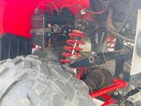 a close up of the front of a red atv