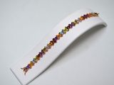 a close up of a white plate with a colorful bracelet on it