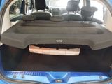 the back of a car with a car bed in the trunk of it