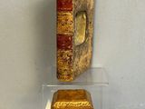 a glass display case with a book on top of it