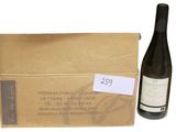 a bottle of wine sitting next to a cardboard box