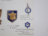 several different badges are displayed on a piece of paper on a table