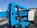 the back end of a blue forklift is parked in a parking lot
