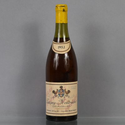 an old bottle of wine sitting on top of a glass table