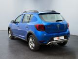 the rear end of a blue car parked in a showroom
