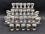 a lot of cups that are sitting on a clear shelf