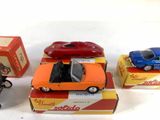 several toy cars are sitting on top of boxes on a white surface