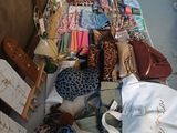 a long table with many bags and bags on it