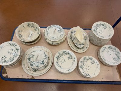 many plates and bowls on a tray on the floor