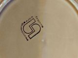 a close up of a plate with a logo on it