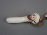 a figurine of a man with a beard on a stick