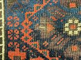 an image of a blue and orange area rug with a cat laying on top of it
