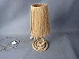 a lamp that has a rope on top of it