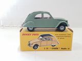 a green toy car sitting on top of a yellow box