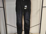 un jean noir suspendu à un portant dans un magasin de vêtements