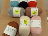 many balls of yarn sitting on top of a table