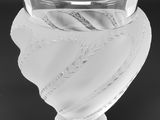 black and white photograph of a glass vase with a label on it