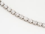 a close up of a diamond necklace on a white surface
