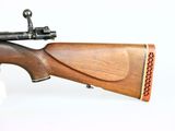 an old rifle with a wooden barrel on a white background
