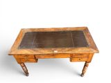 a small wooden table with a leather top on it