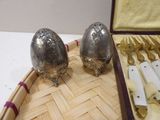 two silver salt and pepper shakers on a tray