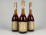 three bottles of wine sitting next to each other on a table