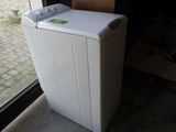 an image of a white washing machine in front of a window