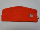 an orange hat with a metal button on top of it