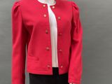 a mannequin wearing a red jacket and black pants