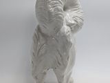 a white statue of a ram standing on a white surface
