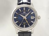 an image of a close up of a wrist watch with a blue dial