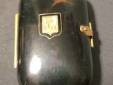 a small black case with a gold emblem on it
