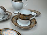 four cups and saucers sitting on a table
